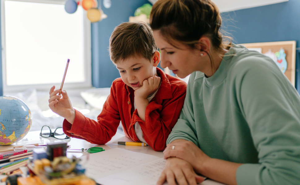 Homeschooling mother helping child 